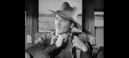 John Wayne as Ringo Kid, welcomed into the stage as a prisoner in Stagecoach (1939)