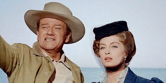 John Wayne as Sam McCord and Capucine as Michelle Bonet, arriving in Alaska in North to Alaska (1960)