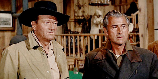 John Wayne as Sam McCord and Stewart Granger as George Pratt, partners who strike it rich in North to Alaska (1960)