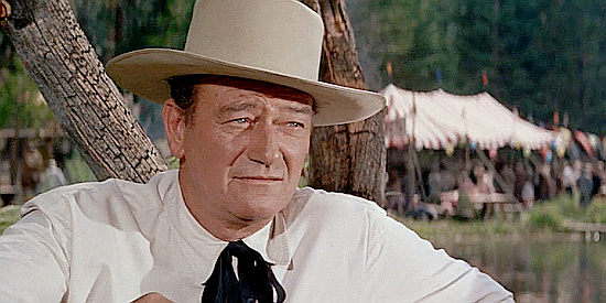 John Wayne as Sam McCord, taking Michelle Bonet to a loggers' festival in North to Alaska (1960)
