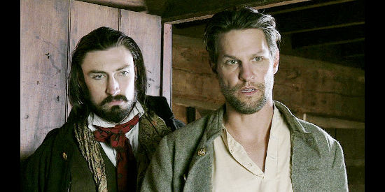 John Wells as Valentine Hatfield and Dylan Vox as Elias Hatfield, checking on a wounded relative in Hatfields and McCoys, Bad Blood (2012)