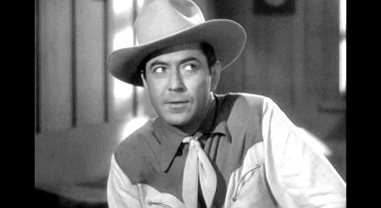 Johnny Mack Brown as Alabam' Brewster, looking for a way to help Bronco Bob escape kidnappers in Ride 'Em Cowboy (1942)