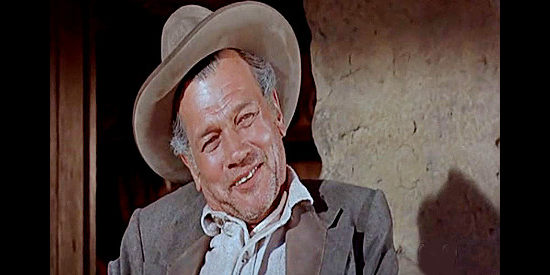 Joseph Cotton as John Breckenridge, Belle's husband, humored by O'Mally's announcement that he plans to steal Belle in The Last Sunset (1961)