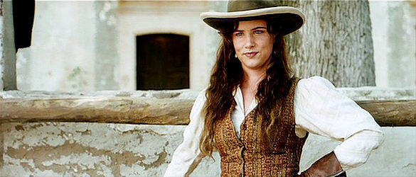 Juliette Lewis as Maria Sullivan, watching Blueberry try to ride one of her dad's horses in Renegade (2004)