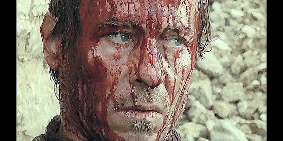 Karel Roden as The Stranger, wounded during his encounter in town in Dead Man's Bounty (2006)