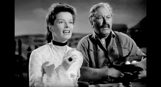 Katherine Hepburn as Lutie Brewton, making plans for the ranch house alongside Jeff (Edgar Buchanan), the ranch's book, in The Sea of Grass (1947)