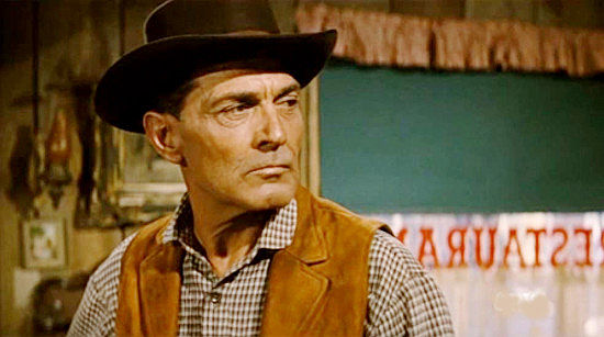 Kent Taylor as Marshal Jim Cogan, recognizing Maverna as a woman who could cause him trouble in The Broken Land (1962)
