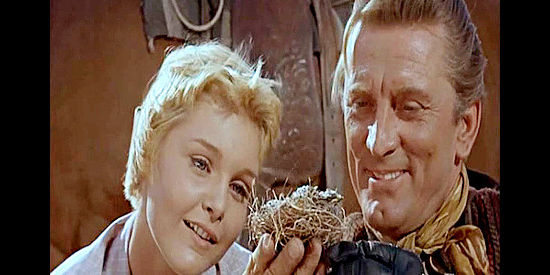 Kirk Douglas as Brendan O'Mally, showing Missy Breckenridge (Carol Lynley) a bird's nest that was nearly trampled by the stock in The Last Sunset (1961)