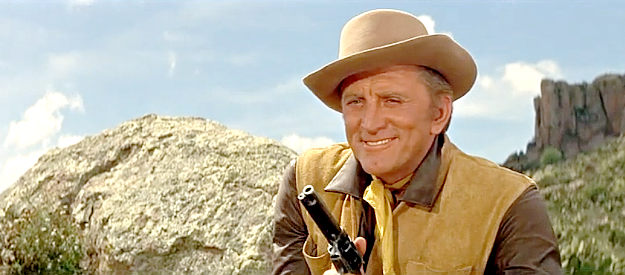 Kirk Douglas as Lomax, a man with lots of reasons to make sure Taw Jackson stays alive in The War Wagon (1967)