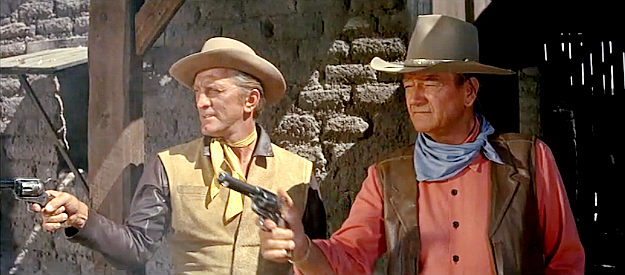 Kirk Douglas as Lomax and John Wayne as Taw Jackson, staying healthy in The War Wagon (1967)