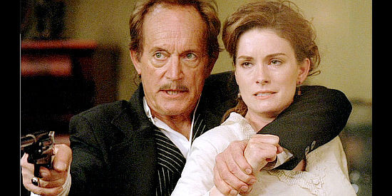 Lance Henriksen as James Monte, using much younger wife Olivia (Jamie Anne Allman) as a shield in Prairie Fever (2008)