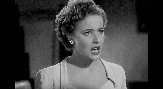 Laraine Day as Lucia Pell, having her teeth inspected by Pancho Lopez in The Bad Man (1941)