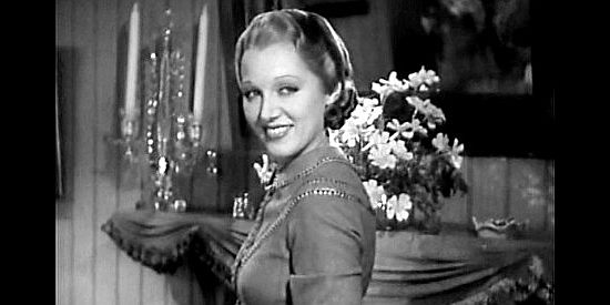 Leila Hyams as Nellie Brian, flashing Bob Culpepper a smile as her mother tries to hurry him along in Yellow Dust (1936)