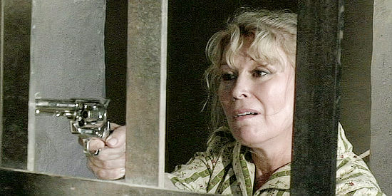 Leslie Easterbrook as Lana Gambol, upset that Johnny has leaked a well-guarded secret in Retribution Road (2007)
