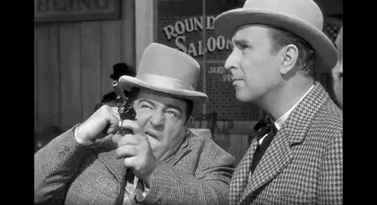 Lou Costello as Chester Wooley fires the shot that starts all the trouble for himself and Duke Egan (Bud Abbott) in The Wistful Widow of Wagon Gap (1947)