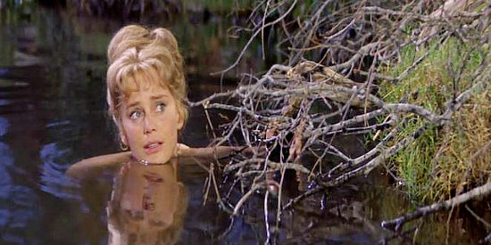 Maria Schell as Sabra Cravet, surprised when three young ruffians show up while she's bathing in Cimarron (1960)
