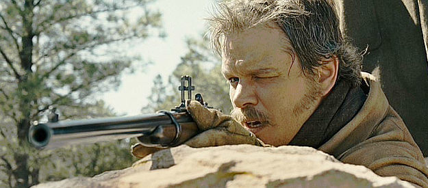 Matt Damon as LaBoeuf, taking aim for a long-distance shot with his Sharps rifle in True Grit (2010)
