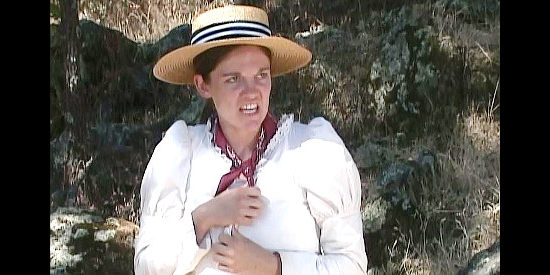 Megan McNally as Olivia Noland, frightened as Dutch Henry and his gang corner her in Three Bad Men (2005)