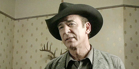Michael Gregory as Sheriff Bob Gambol, dispensing justice in an uncustomary manner in Retribution Road (2007)