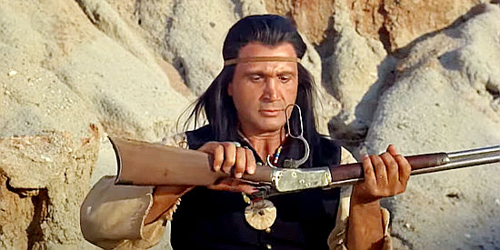 Michael Keep as Cochise, inspecting one of the repeating rifles Cpl. Bodine wants to see the Indians in 40 Guns to Apache Pass (1967)