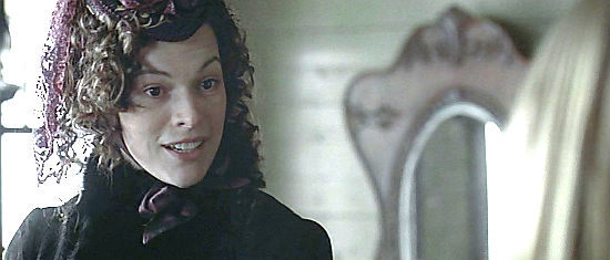 Milla Jovovich as Lucia, extending an invitation in The Claim (2000)