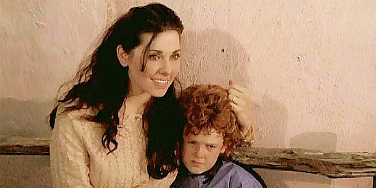 Mindy Dudek as Hannah Jefferson, the sheriff's wife, with orphan Timmy (Shane Ryan Savage) in Return of the Outlaws (2009)
