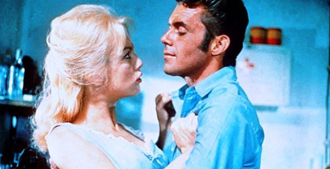Mylene Demongeot as Locha with Dick Bogarde as Anacieto in The Singer, Not the Song (1961)