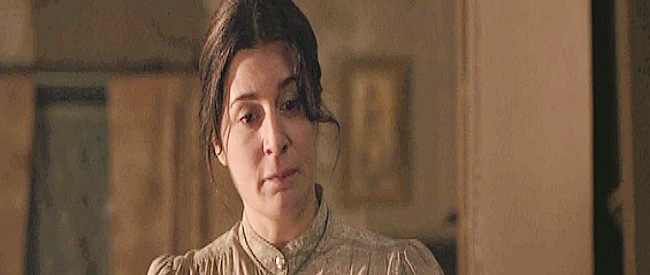 Nicole Oliver as Nancy Shepherd, disagreeing with husband John over his plan to rescue son Isaac in Lonesome Dove Church (2014)