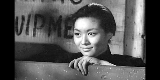 Nobu McCarthy as Kim Sung, rescued from a slave auction by Linc Barrett in Walk Like a Dragon (1960)