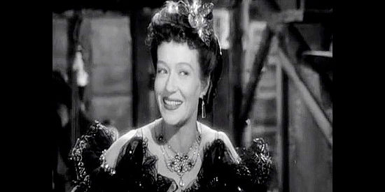 Ona Munson as Jersey Thomas, the dance hall girl with eyes for John Devlin in Dakota (1945)