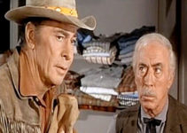 Barry Sullivan as Chaddock, remembering his late wife as store owner Perkins (George Chandler) look son in Buckskin (1968)