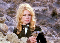 Brigitte Bardot as Irina Lazaar, ready to defend herself in Shalako (1968)
