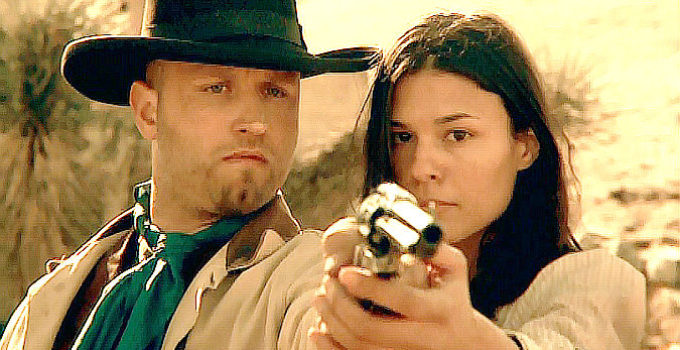 Jarret LeMaster as Nate, getting lessons in shooting left-handed from Em (Michelle Acuna) in Bounty (2009)