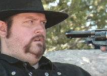 PROMO -- Jeremy Owen as Leonard Cross, under a fellow gang member's pistol in The Righteous and the Wicked (2010)