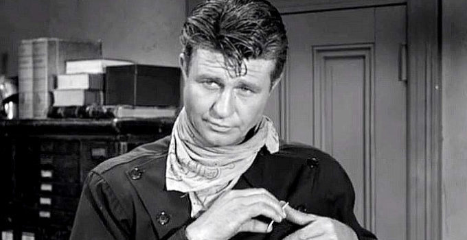 Jim Davis as Case Britton, pinning on a marshal's badge to help residents in the town that wanted to hang him in Noose for a Gunman (1960)