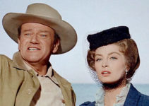 John Wayne as Sam McCord and Capucine as Michelle Bonet, arriving in Alaska in North to Alaska (1960)