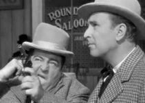 Lou Costello as Chester Wooley fires the shot that starts all the trouble for himself and Duke Egan (Bud Abbott) in The Wistful Widow of Wagon Gap (1947)
