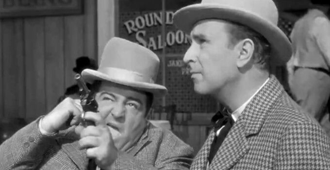 Lou Costello as Chester Wooley fires the shot that starts all the trouble for himself and Duke Egan (Bud Abbott) in The Wistful Widow of Wagon Gap (1947)