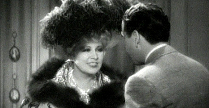 Mae West as Ruby Carter, listening to the Tiger Kid (Roger Pryor) beg for forgiveness in Belle of the Nineties (1934)