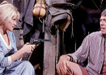 Margaret Blye as Billie Copperud, trying to keep Lewton Cole (James Coburn) at bay with a pistol in Waterhole #3 (1967)