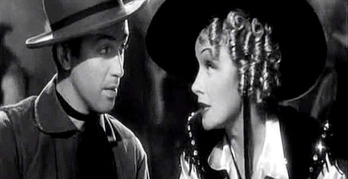 Marlene Dietrich as Frency trying to warn Destry (James Stewart) that he's asking too many questions in Destry Rides Again (1939)