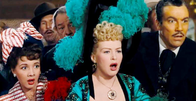 Olga San Juan as Conchita, Betty Grable as Freddie Jones and Cesar Romero as Blackie react to a shocking turn of events in The Beautiful Blonde from Bashful Bend (1949)