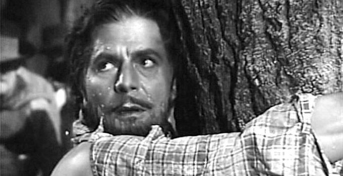 Warner Baxter as Joaquin Murrieta, watching another injustice unfold as he waits to be whipped in Robin Hood of El Dorado (1936)