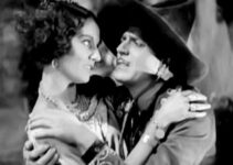 Warner Baxter as The Cisco Kid, planning to flee to Portugal with Tonia Maria (Dorothy Burgess) until he discovers the truth In Old Arizona (1928)