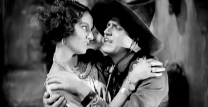 Warner Baxter as The Cisco Kid, planning to flee to Portugal with Tonia Maria (Dorothy Burgess) until he discovers the truth In Old Arizona (1928)