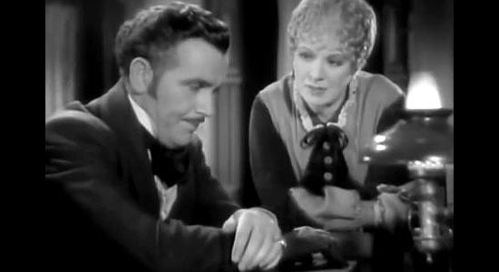 Preston Foster as John Oakhurst and Margaret Irving as The Duchess, discussing their partnership in The Outcasts of Poker Flat (1937)