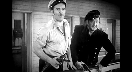 Preston Foster as Paxton Bryce and Richard Dix as Dan Taylor, chasing off a cattle thief in American Empire (1942)