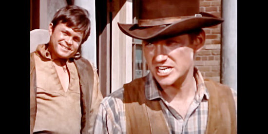 Preston Pierce as Tige McCoy, making a point with townsfolk while a member of his gang looks on in Young Fury (1965)
