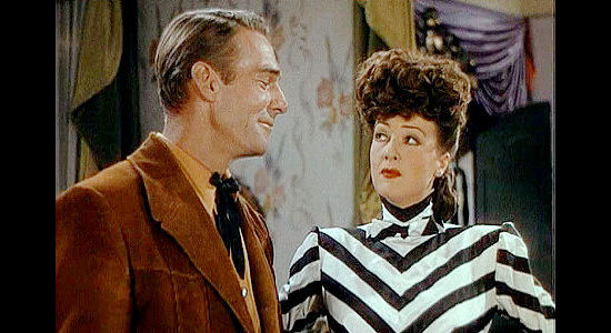 Randolph Scott as Honest John Calhoun and Gypsy Rose Lee as Belle De Valle, reunited and ready to make sparks fly in Belle of the Yukon (1944)