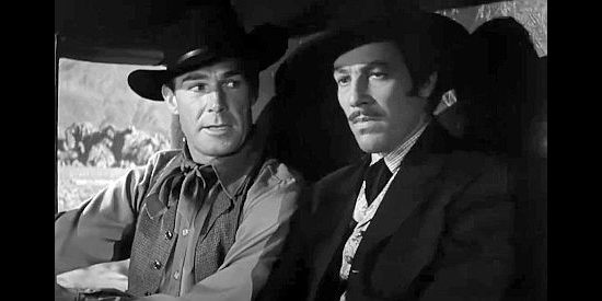 Randolph Scott as Wyatt Earp and Cesar Romero as Doc Holliday, discussing the latter's decision to leave Tombstone in Frontier Marshal (1939)